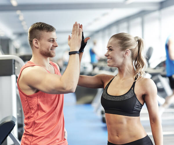 Couple high fives at gym The Club Maui